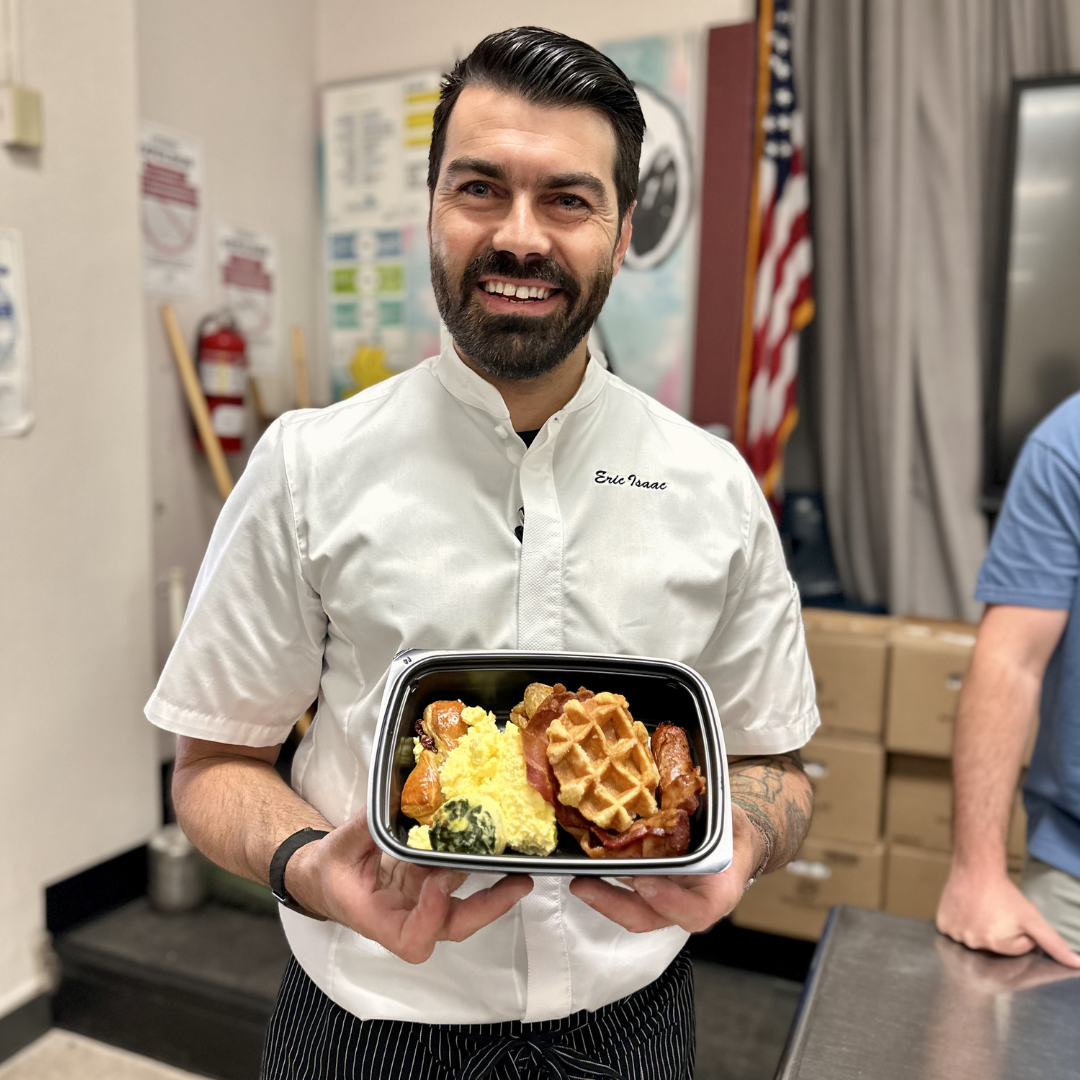 A chef holds a plate of breakfast at Cahlan ES