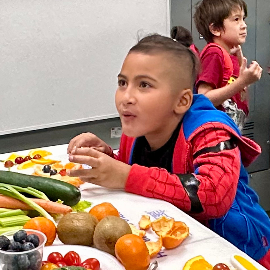 A kid eating produce