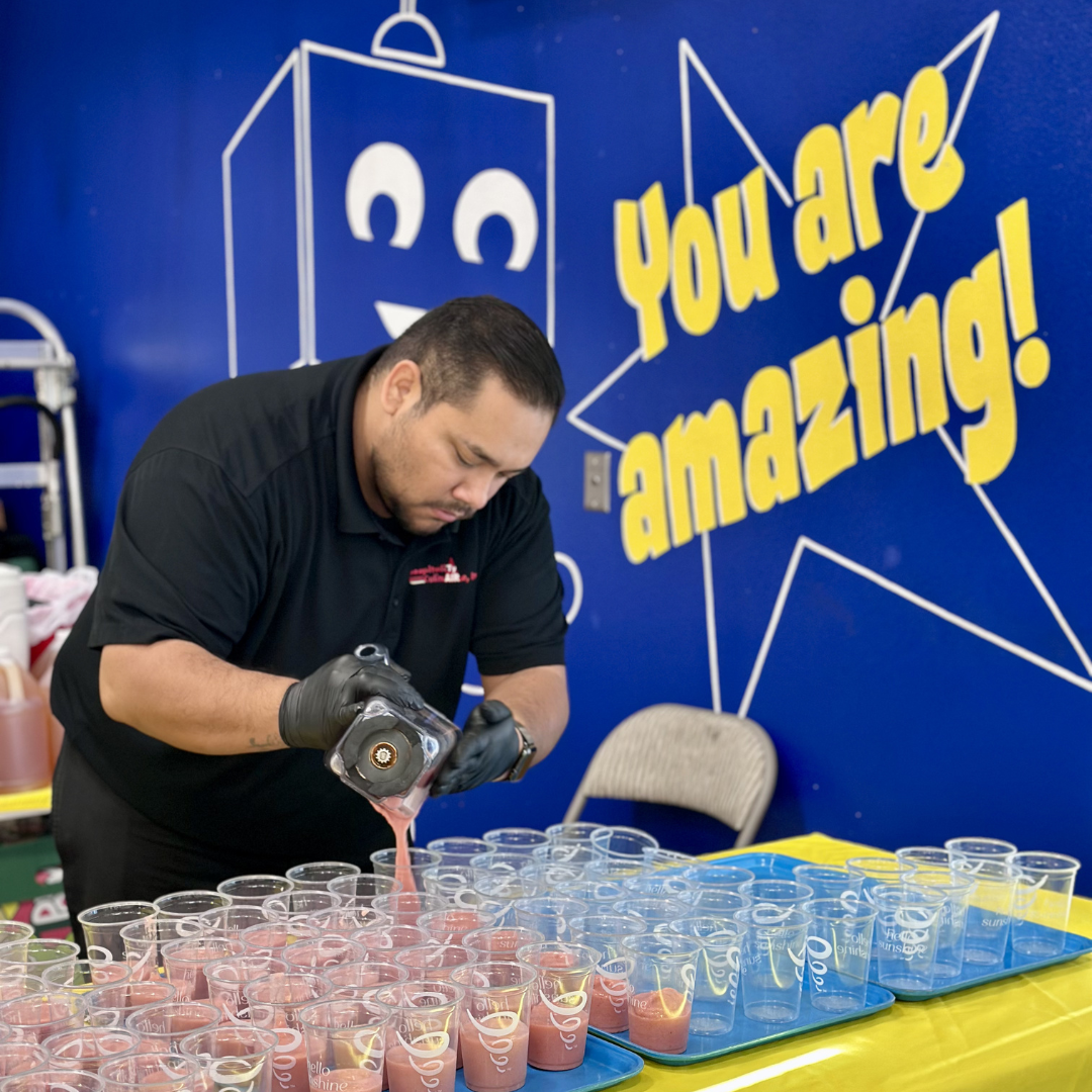 A man pours smoothies into a cup