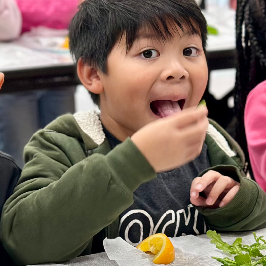 A young male student eats arugula at Ries ES