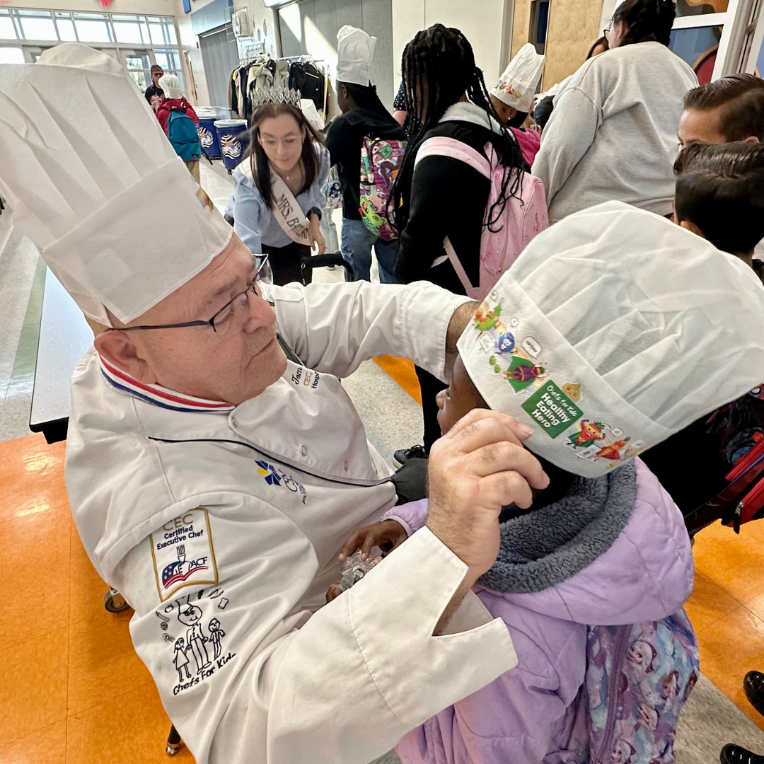 Ashley-Katherine and Tom Pass Out Hats to Kids