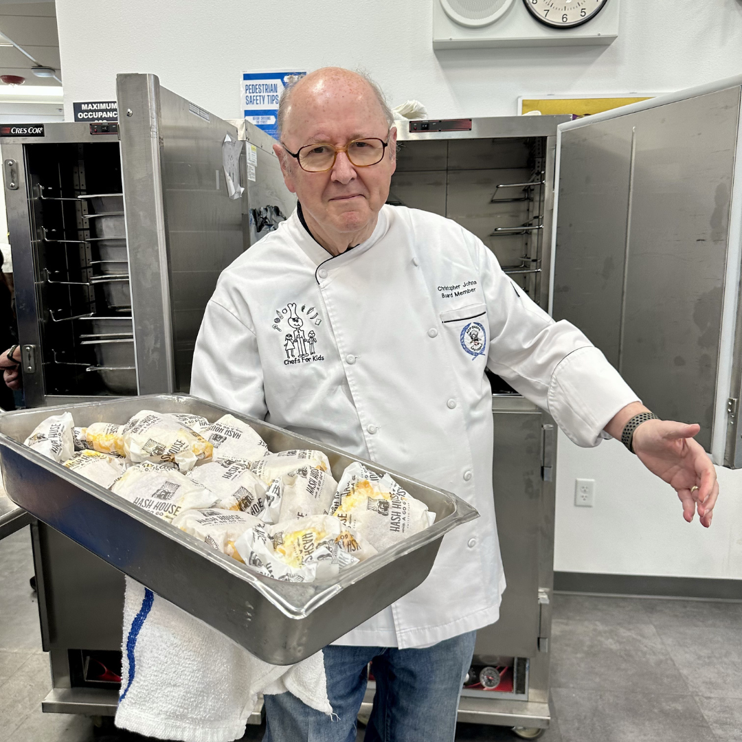 Chef Chris Johns holds a tray of sandwiches