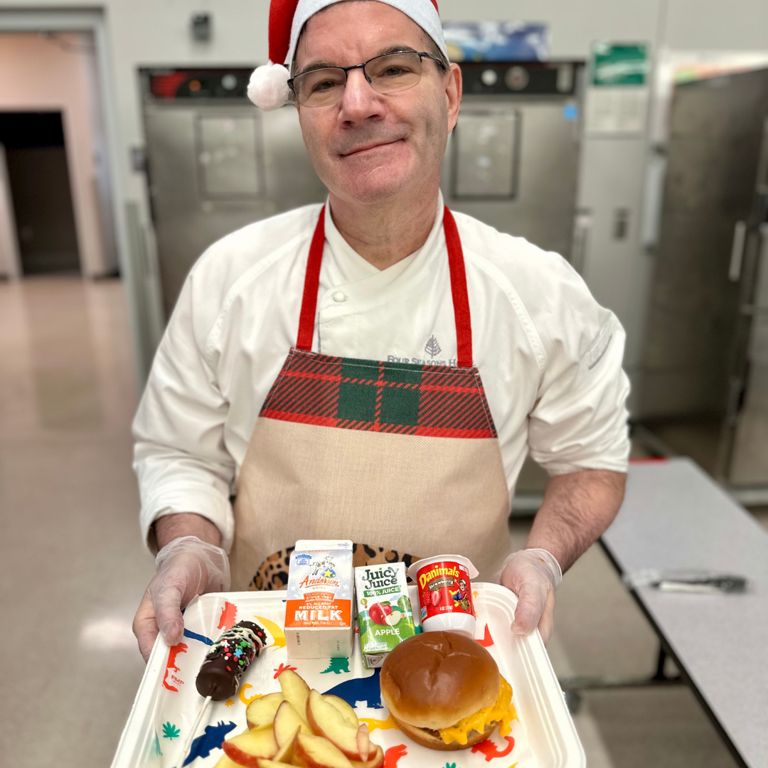Chef Michael Goodman of Four Seasons Las Vegas Holds a Tray of Breakfast Created By His Team