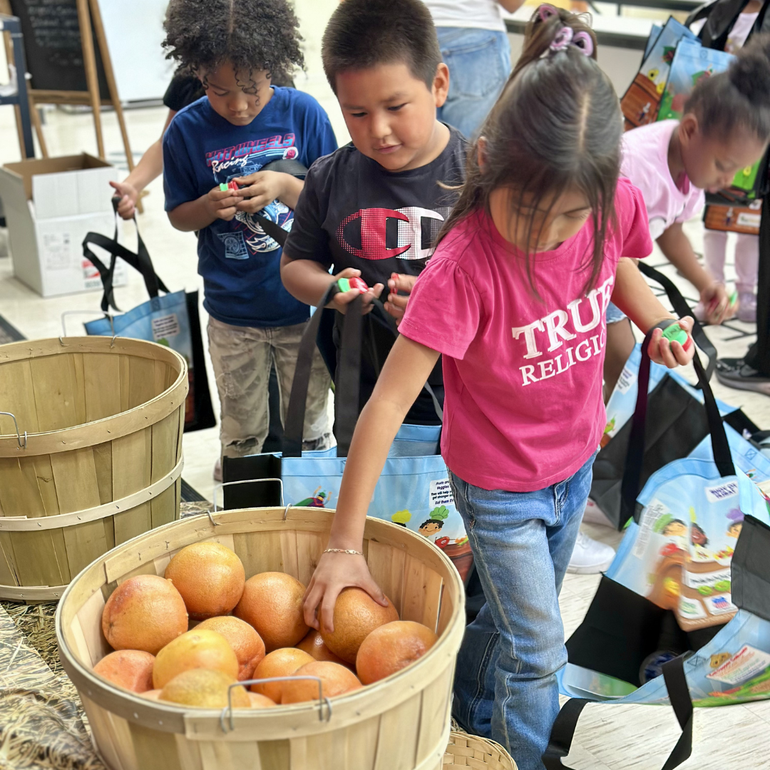 Children shopping at a farmers market