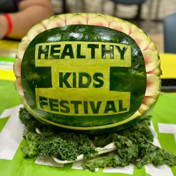 A watermelon with the words Healthy Kids Festival carved in it