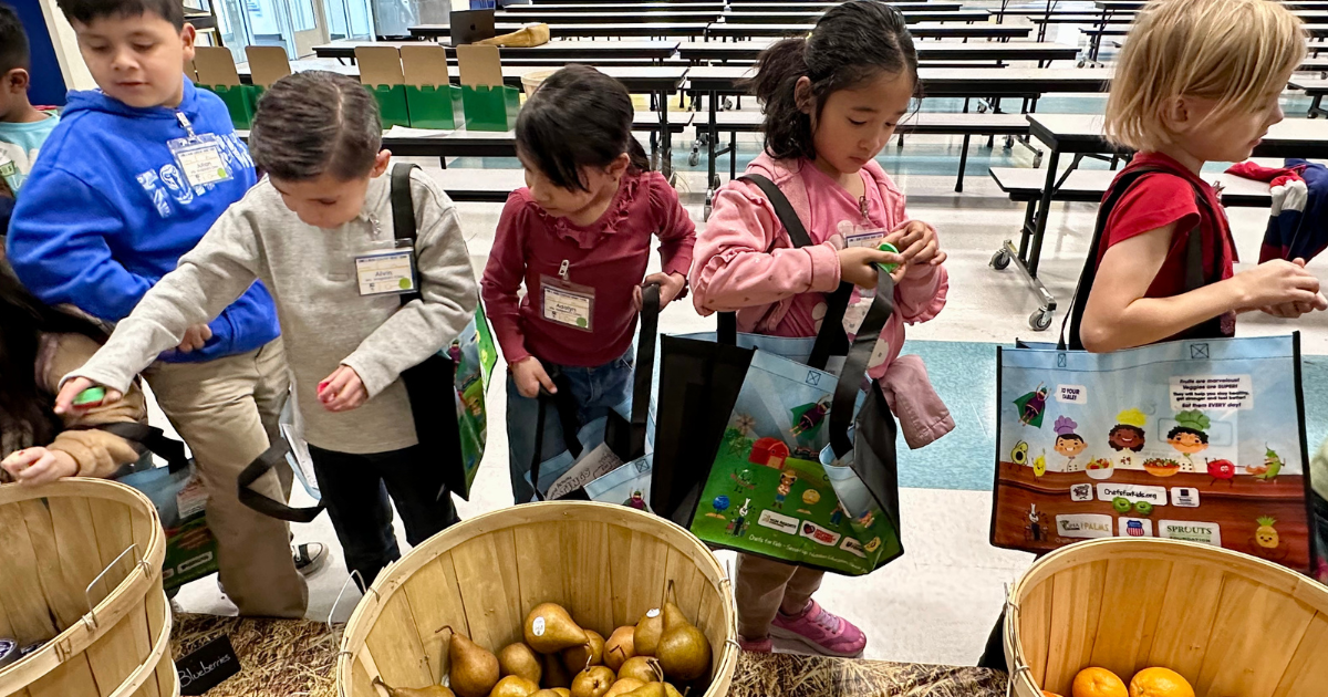 Kids at Lomie Heard ES pick produce out of baskets