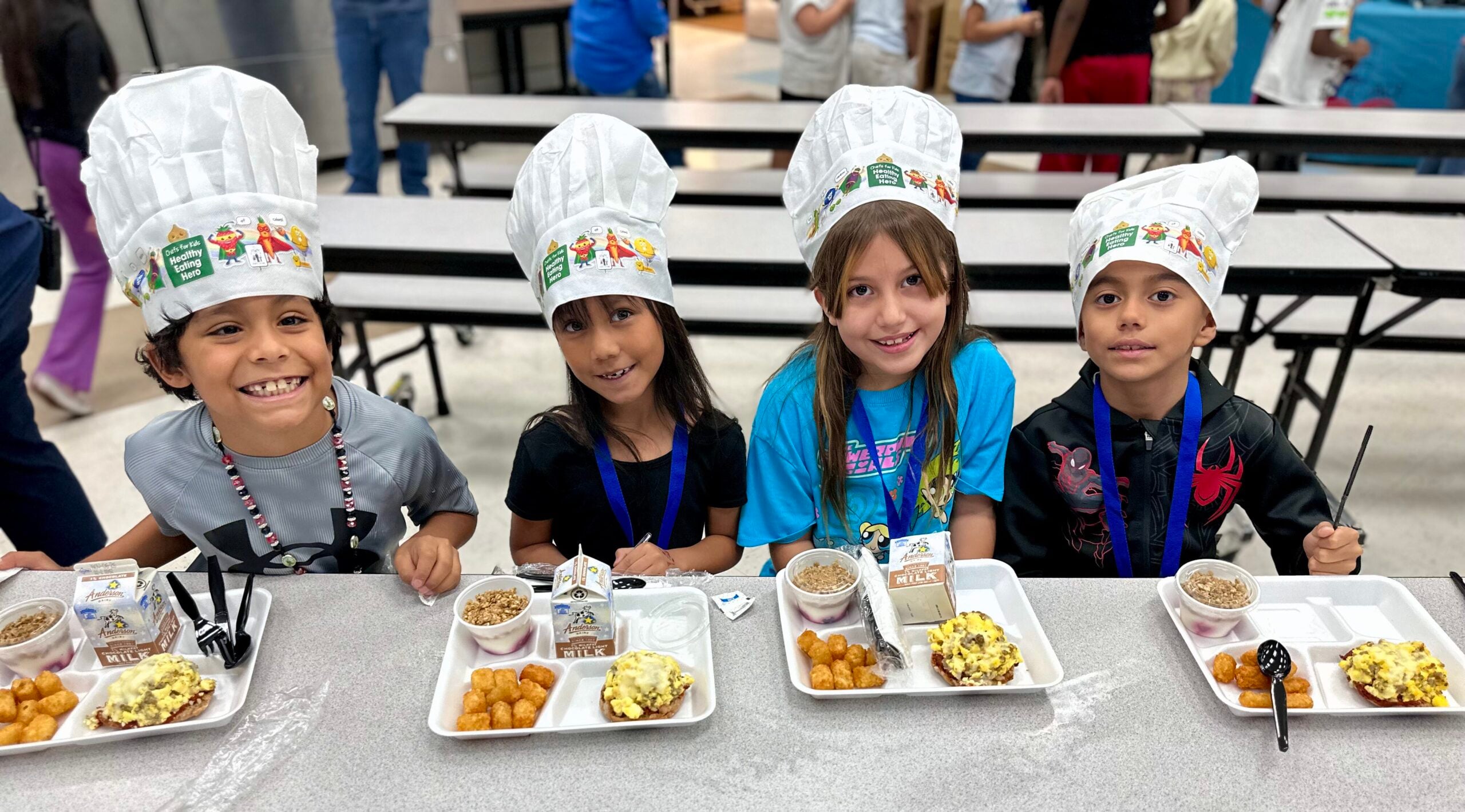 Kids eating at a cafeteria table at Woolley ES