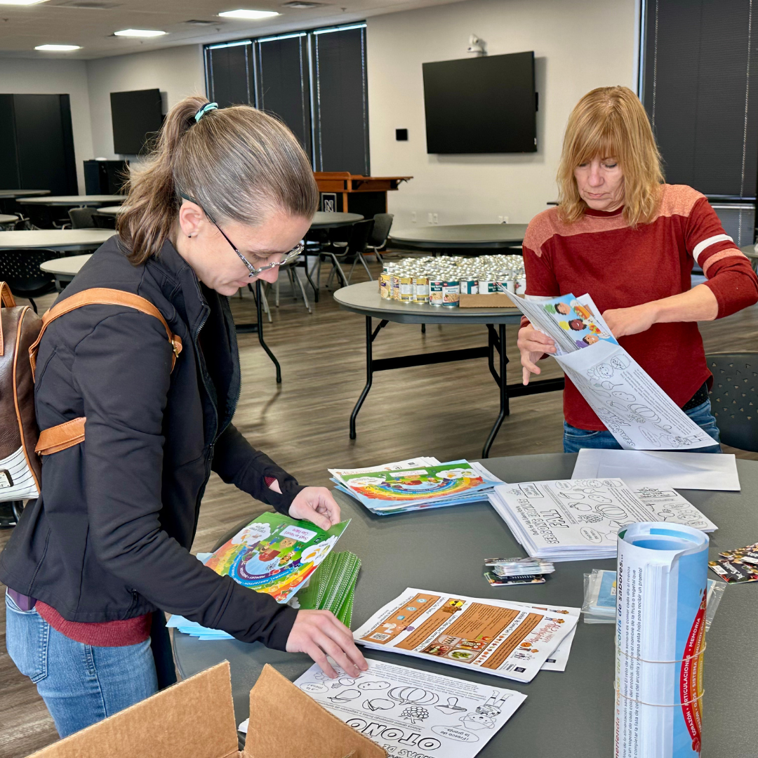 MGM volunteers stuff envelopes with nutrition education info