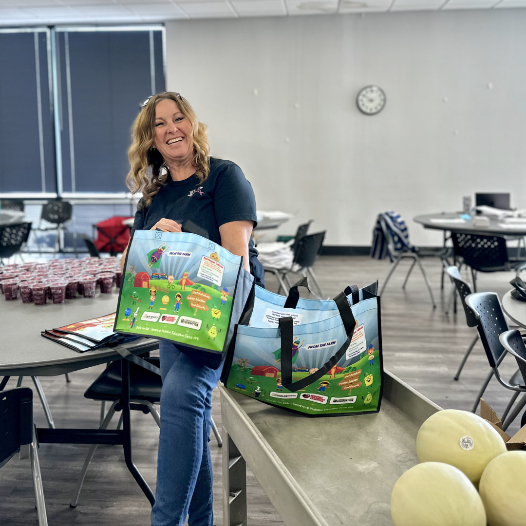 Plus Credit Union Employee Packing A Grocery Bag with Cantaloupe