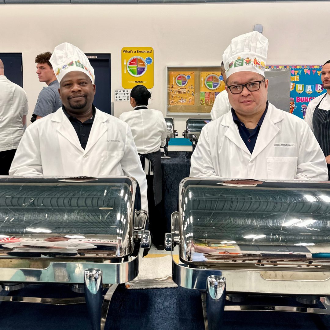 Two Aria chefs prep breakfast for students at Arturo Cambeiro ES
