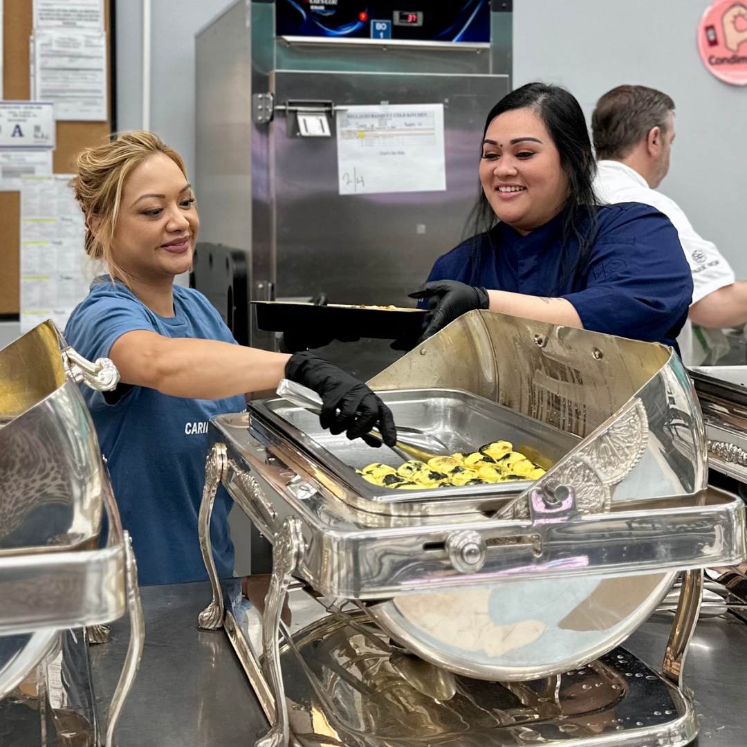 Two female MGM chefs prepare breakfast