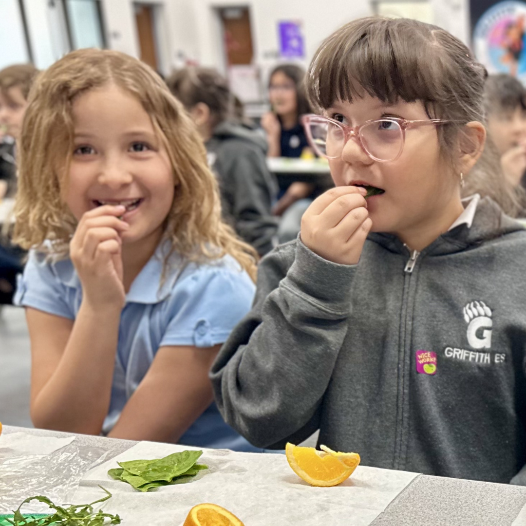 Two female students participating in a taste test