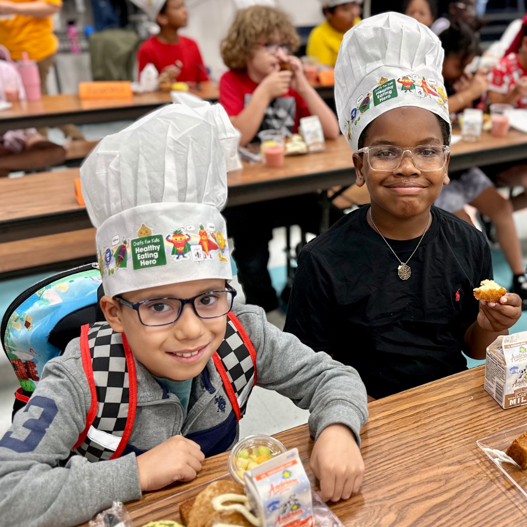 Two male students at Arturo Cambeiro enjoy breakfast