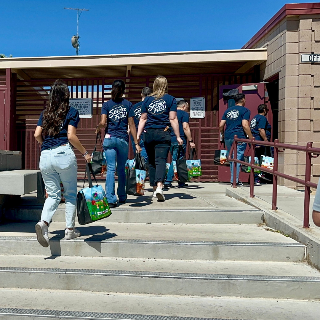 Volunteers unload bags of food into the school